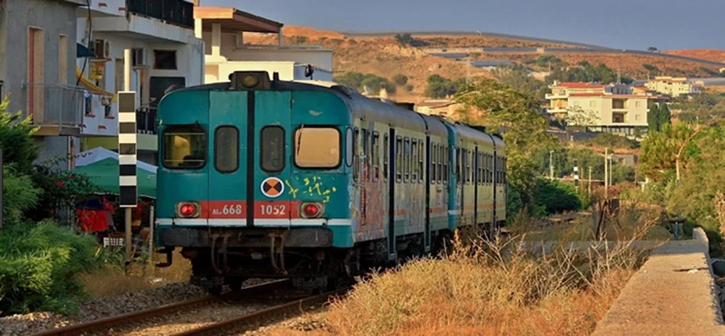 A regional train travelling through a dry landscape